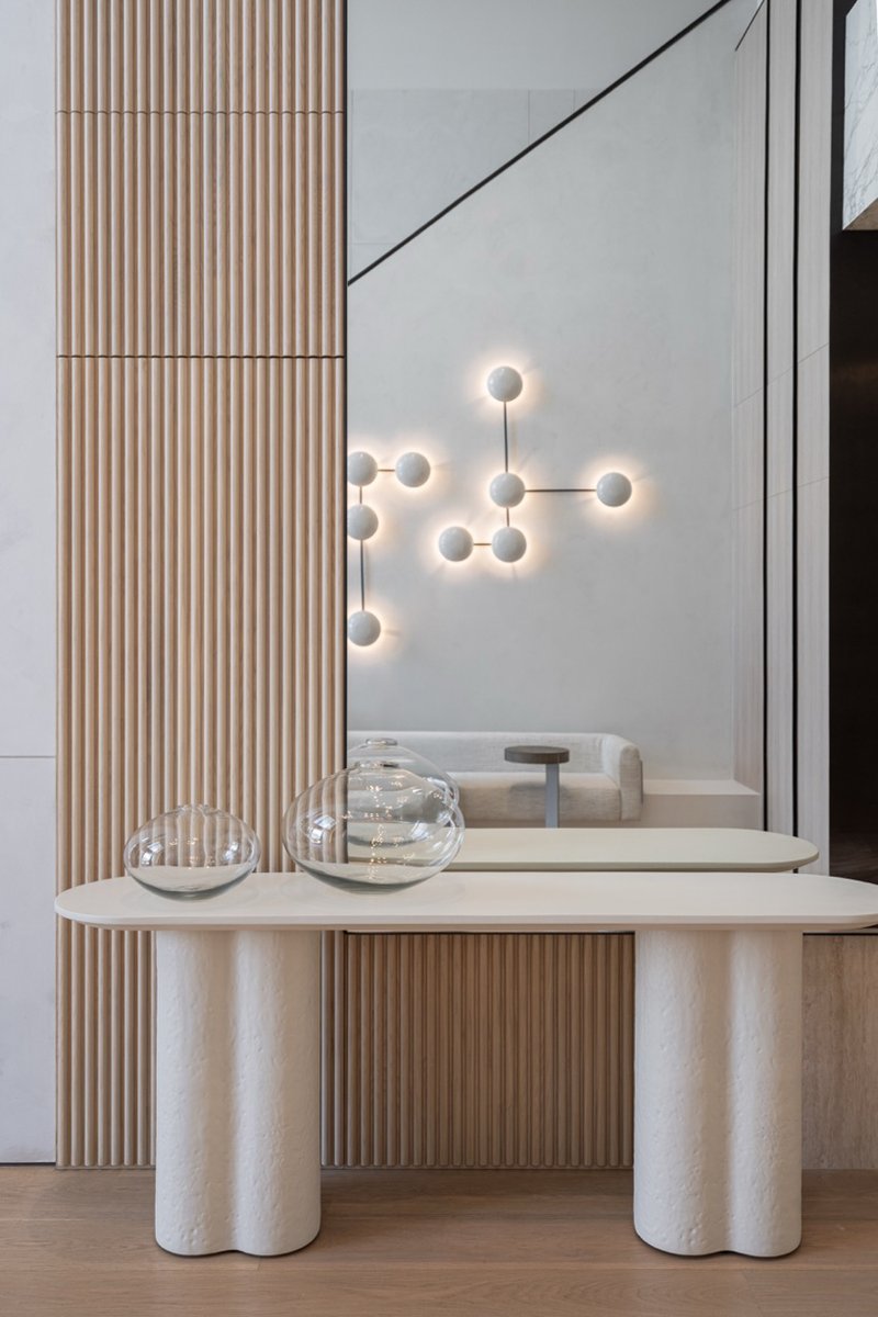 wood and porcelain interplay across curved interiors in florida renovation