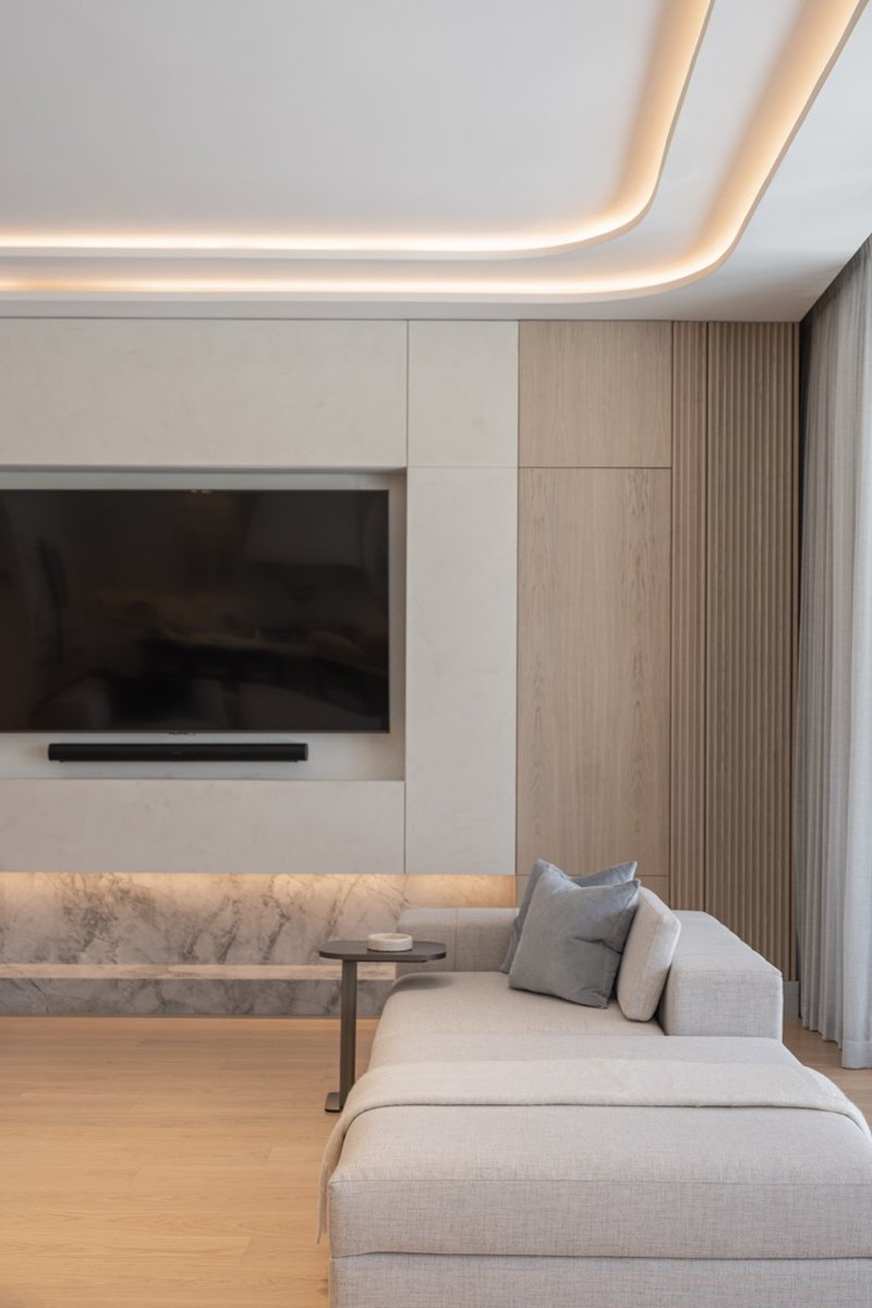 wood and porcelain interplay across curved interiors in florida renovation