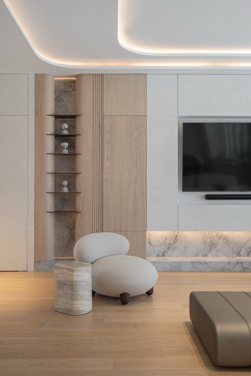 wood and porcelain interplay across curved interiors in florida renovation