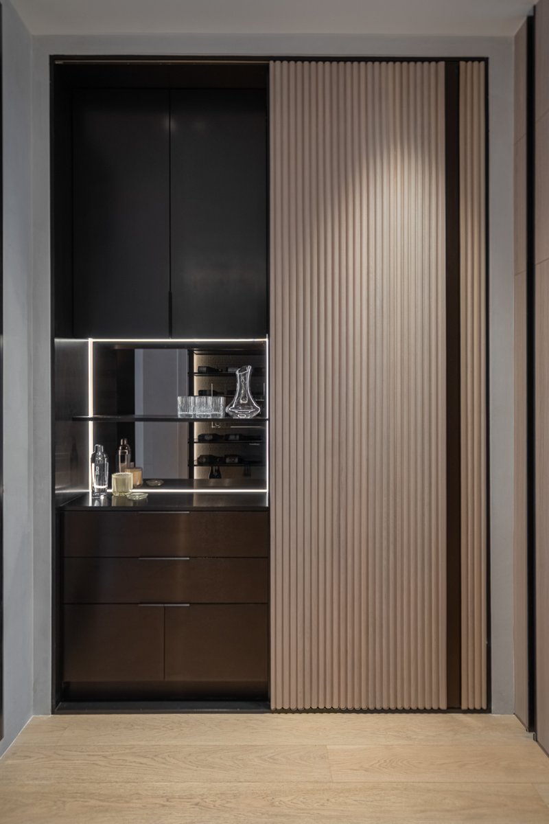 wood and porcelain interplay across curved interiors in florida renovation