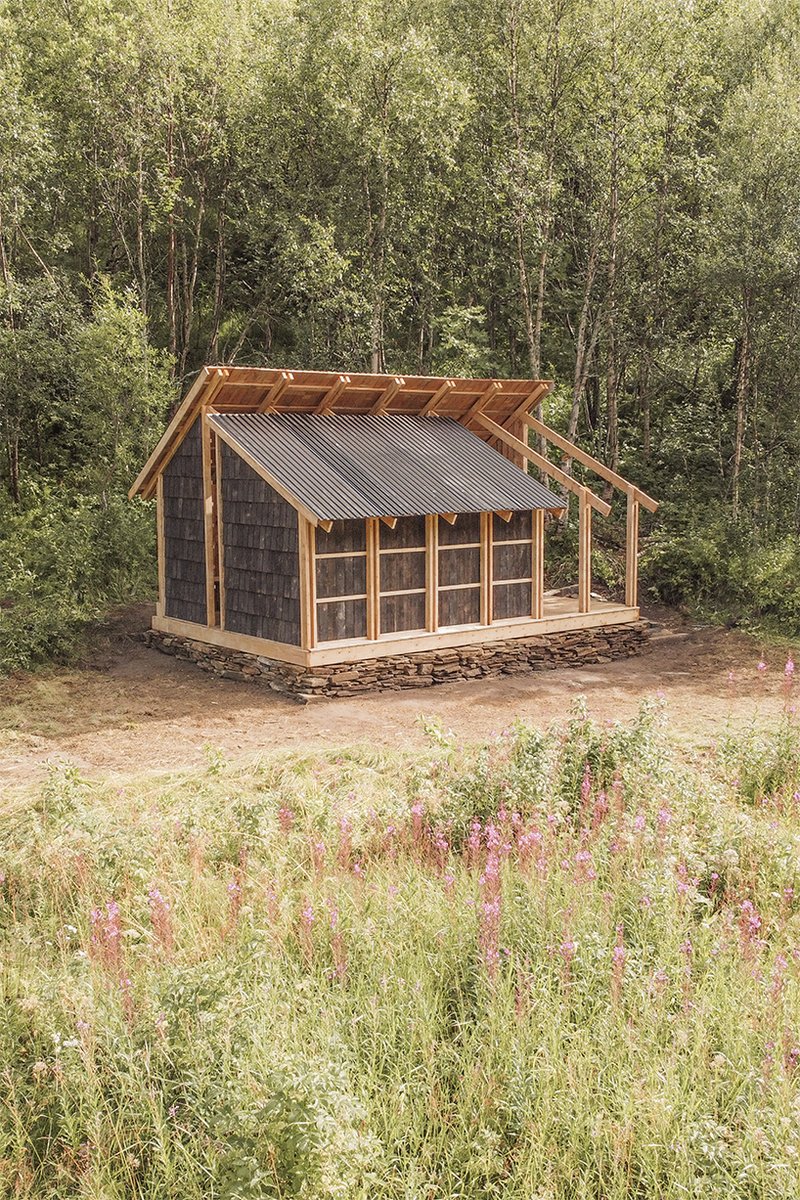 student collective builds fireplace shelter from reclaimed materials in northern norway
