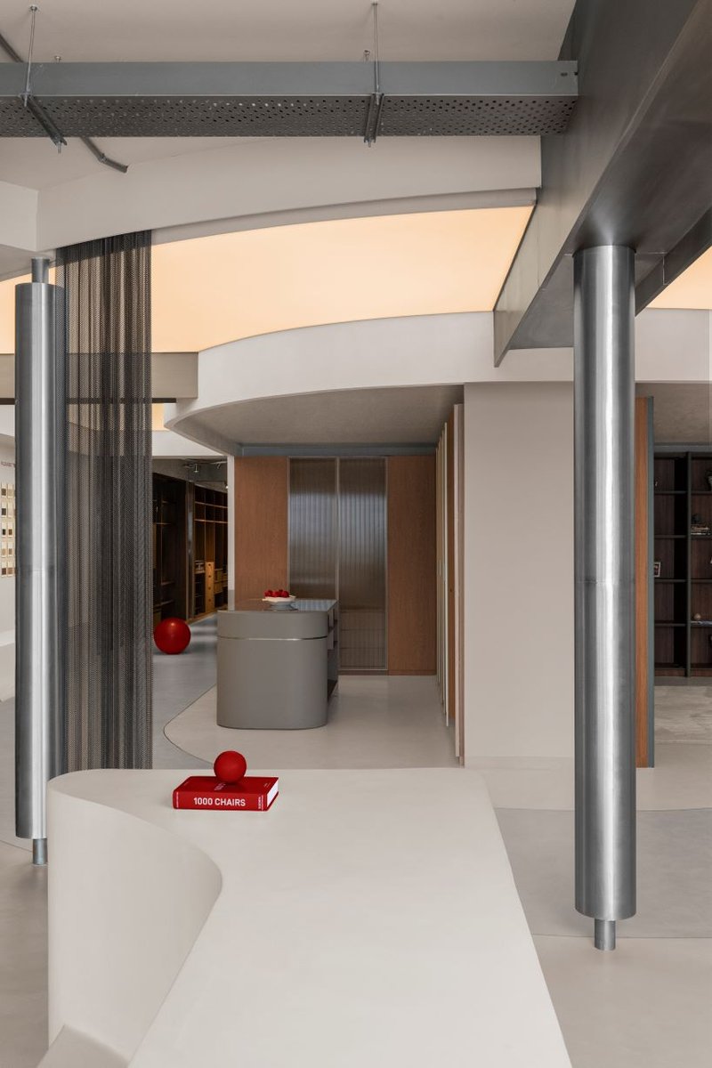 concrete and steel textures shape showroom in india organized as a continuous loop